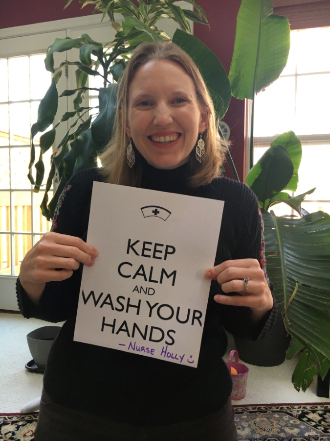 Nurse Holly holding a sign that says Keep calm and wash your hands. -Nurse Holly